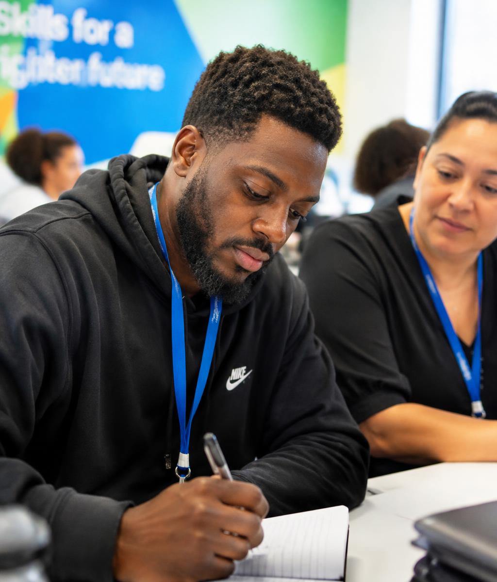 An adult taking notes during a workforce-readiness training session
